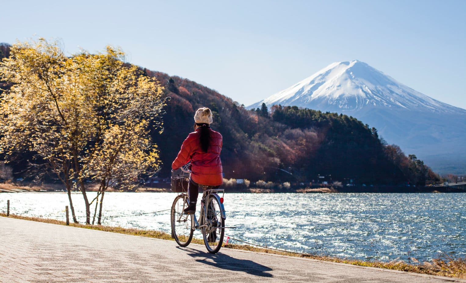 Girl riding her bicycle by Mt. Fuji in Japan