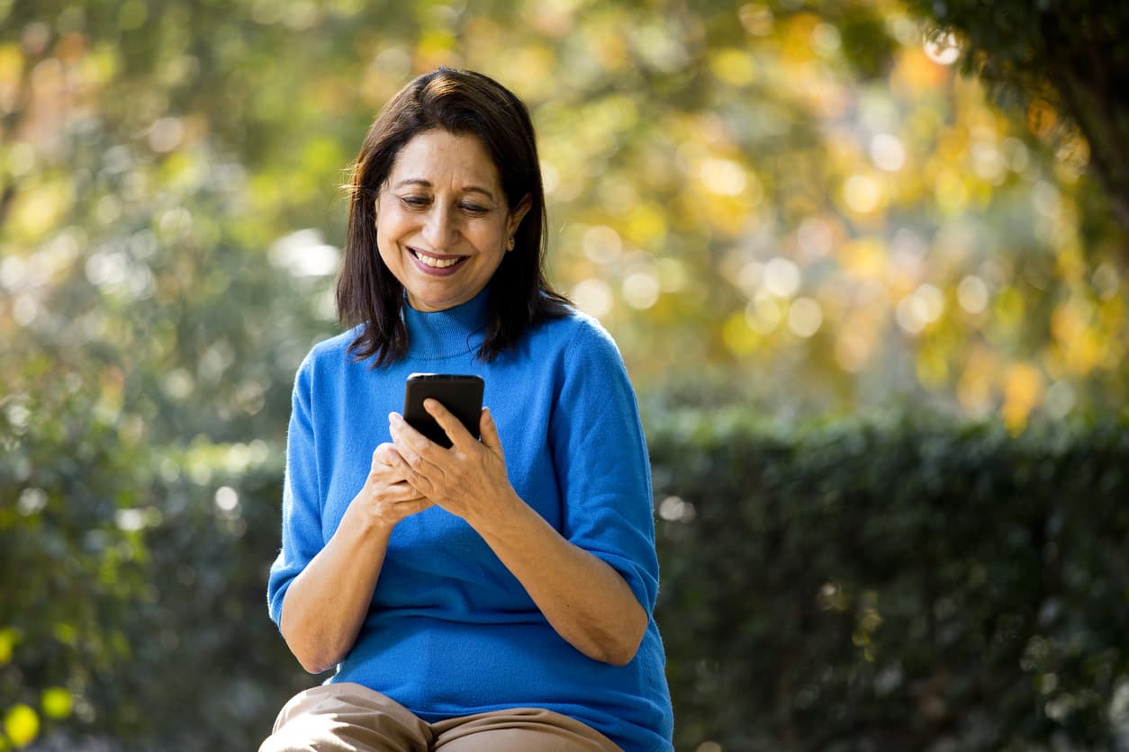 Smiling woman using her phone
